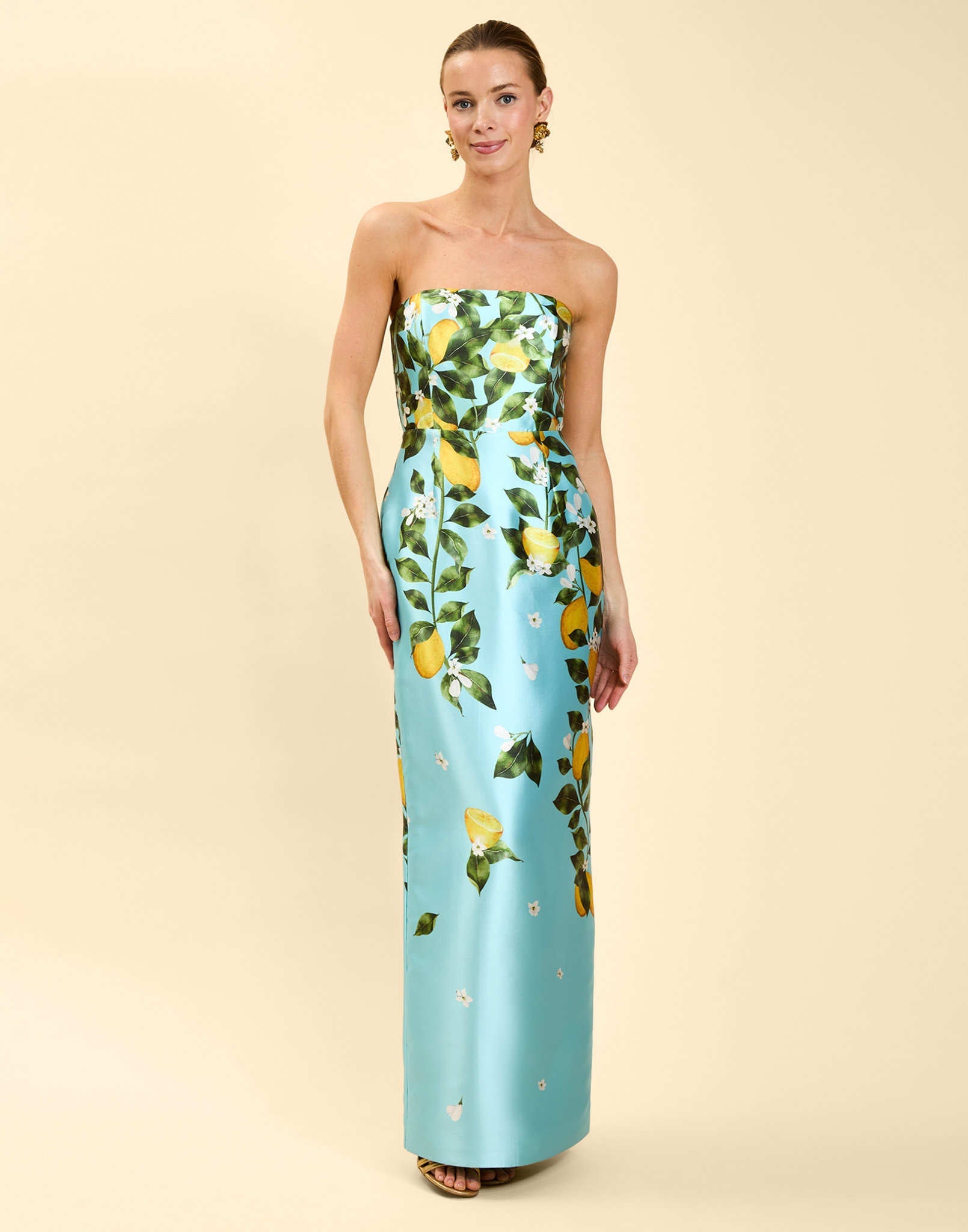 Solstice Gown in Sorrento Citrus poly silk twill with strapless neckline, removable bow, convertible bodice, and side pockets.