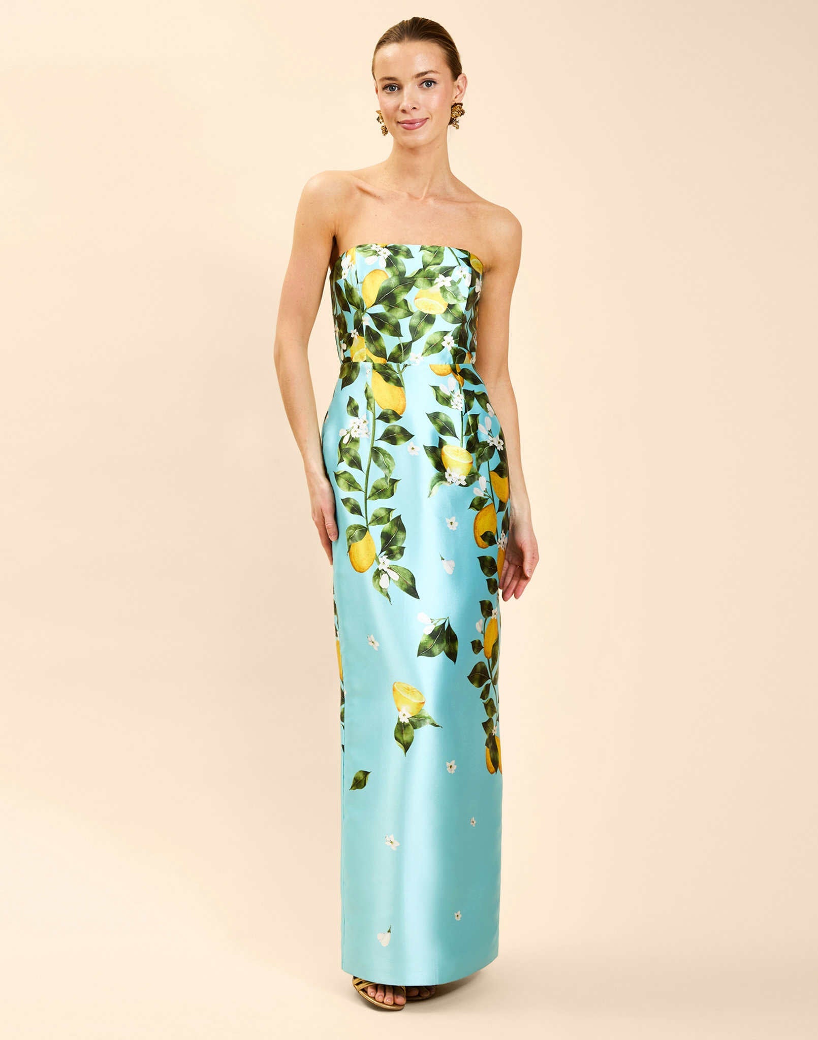 Solstice Gown in Sorrento Citrus poly silk twill with strapless neckline, removable bow, convertible bodice, and side pockets.