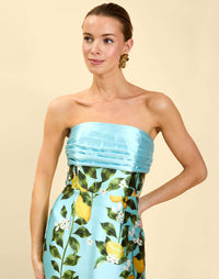 Solstice Gown in Sorrento Citrus poly silk twill with strapless neckline, removable bow, convertible bodice, and side pockets.