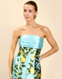 Solstice Gown in Sorrento Citrus poly silk twill with strapless neckline, removable bow, convertible bodice, and side pockets.