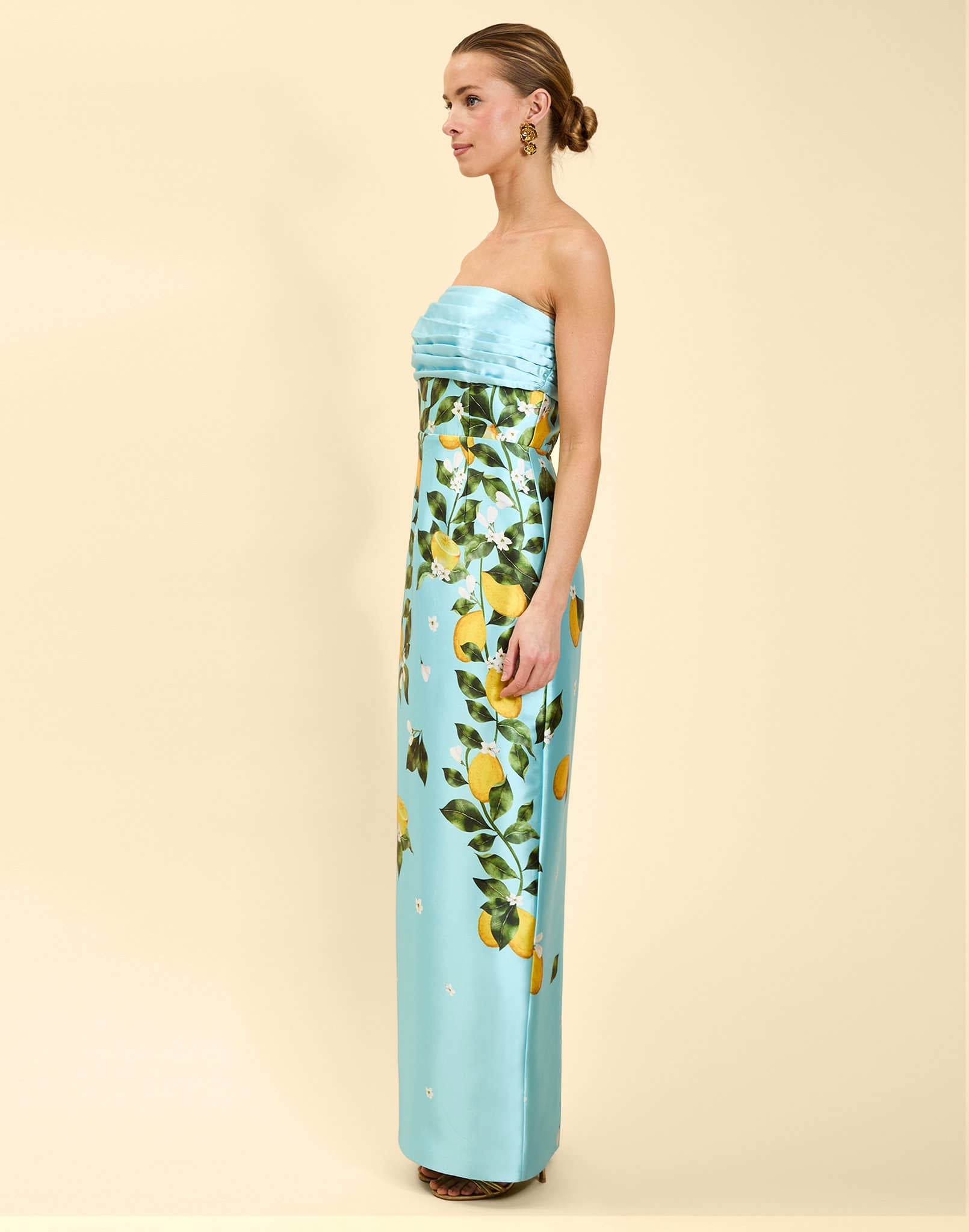 Solstice Gown in Sorrento Citrus poly silk twill with strapless neckline, removable bow, convertible bodice, and side pockets.
