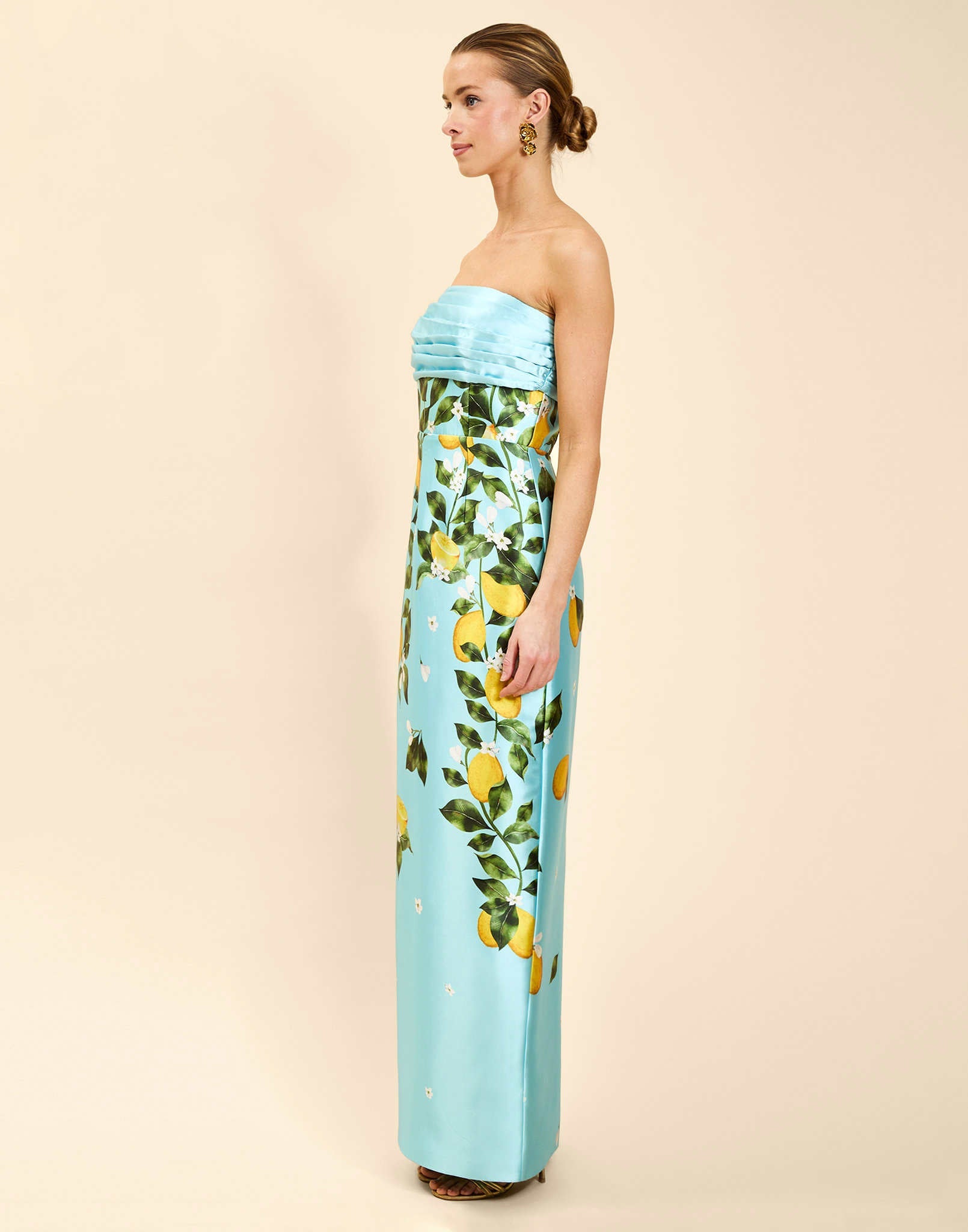 Solstice Gown in Sorrento Citrus poly silk twill with strapless neckline, removable bow, convertible bodice, and side pockets.