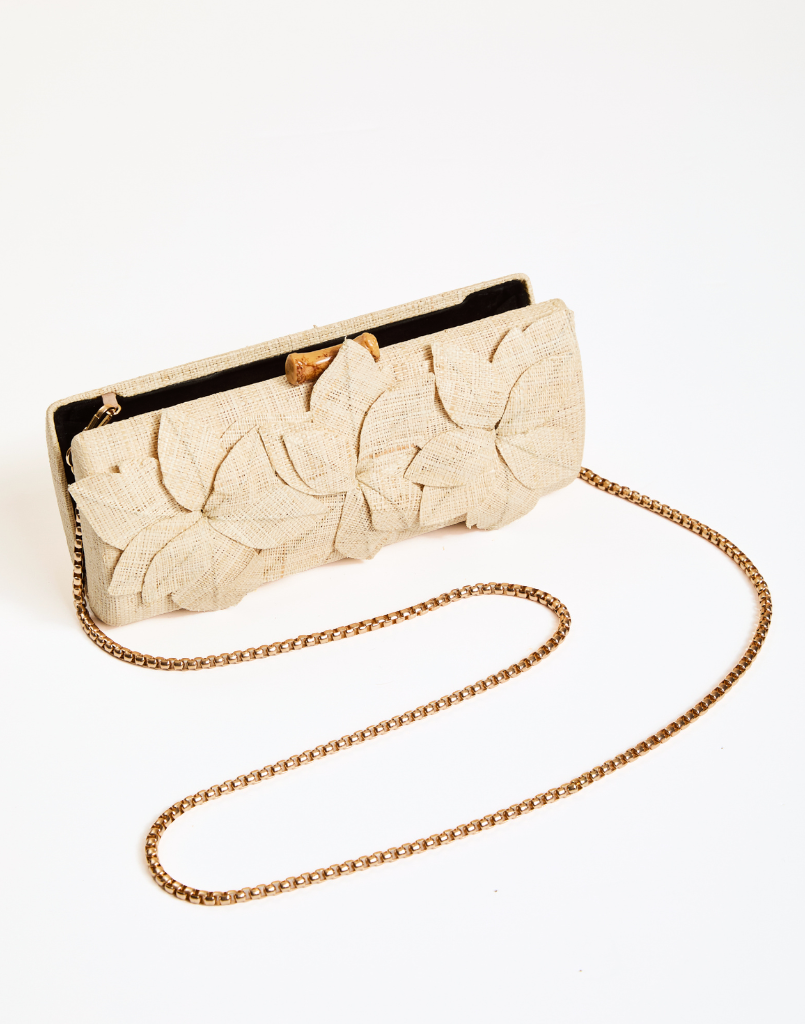 Peridot Raffia Clutch with 3D floral details, bamboo clasp, and removable gold chain strap for crossbody wear.