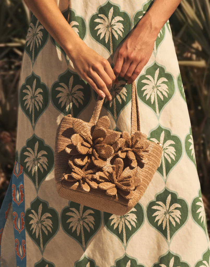Esperanza Flower Bag in raffia with 3D floral appliqué, top handles, and removable gold chain strap