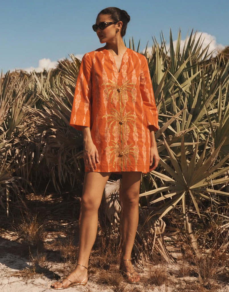 Ines Caftan Mini Dress in Hibiscus Mosaic linen with embroidered palm details, djellaba collar, and relaxed caftan silhouette.