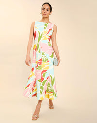 Woman wearing the Mestiza Sunnyside Convertible Midi Dress in Tuscan Daydreaming print, featuring a convertible neckline, fitted bodice, fit-and-flare skirt, and lightweight stretch crepe fabrication.
