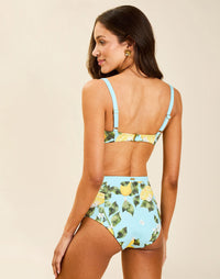 Model wearing Matera High-Waist Bikini Bottom in Sorrento Citrus with bow detail and full back coverage.