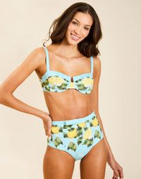 Model wearing Matera High-Waist Bikini Bottom in Sorrento Citrus with bow detail and full back coverage.