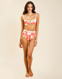 Model wearing Matera High-Waist Bikini Bottom in Huckleberry Mandarin with bow detail and full back coverage.