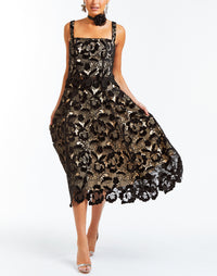 Black velvet top in floral laser cut lace, straight neckline, scalloped hem, and concealed zipper in back.