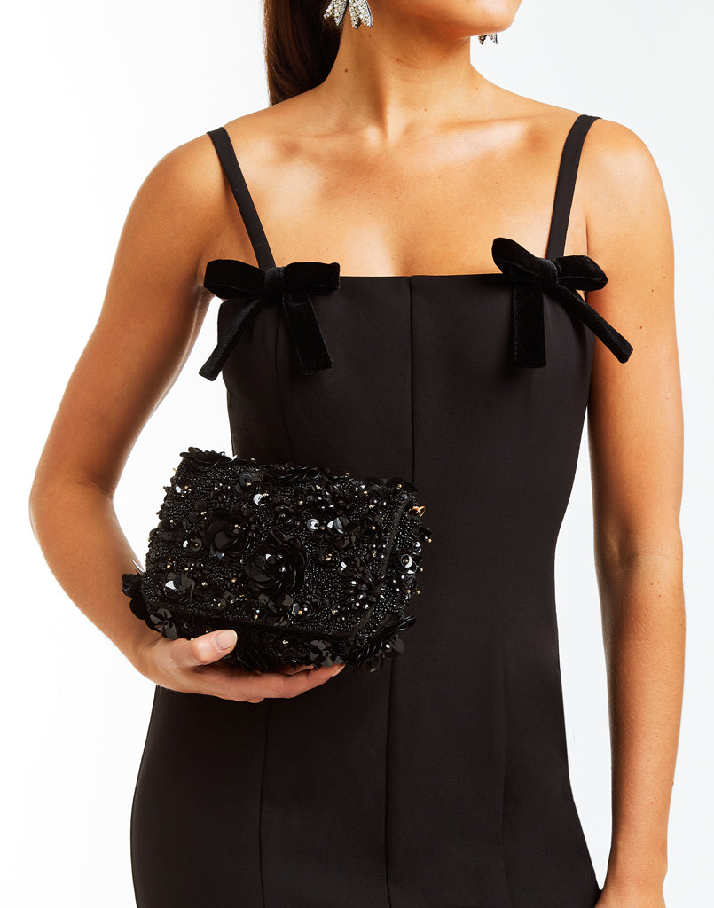  black clutch with beaded florets and gold cross body chain  