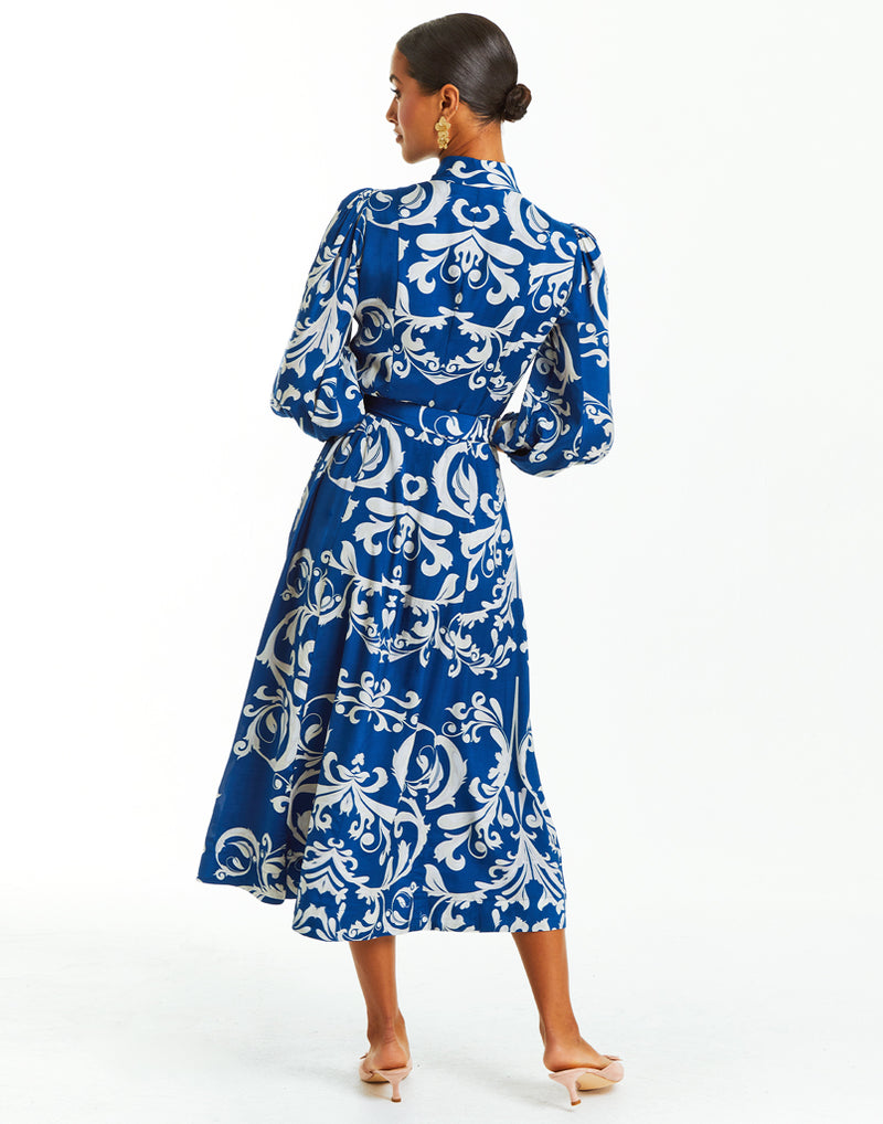 Blue and ivory belted midi dress with arabesque print. Sleeves, mandarin collar and pockets. 
