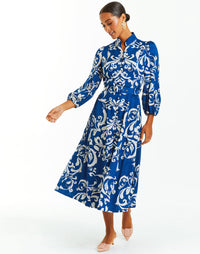 Blue and ivory belted midi dress with arabesque print. Sleeves, mandarin collar and pockets. 