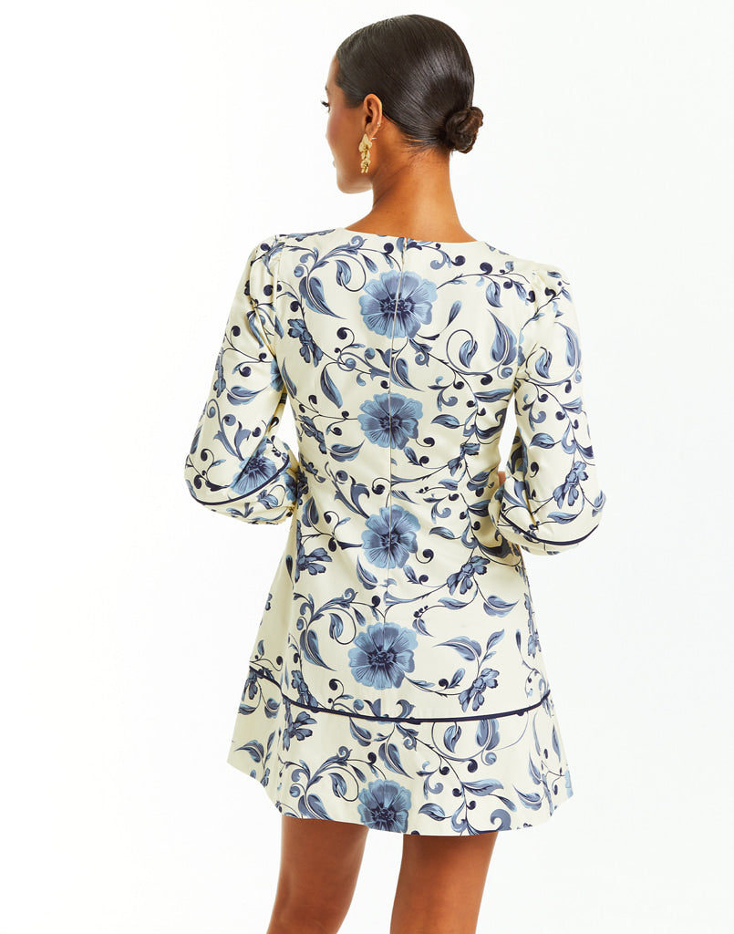 Ivory mini dress with ¾ length sleeves and blue floral print design.