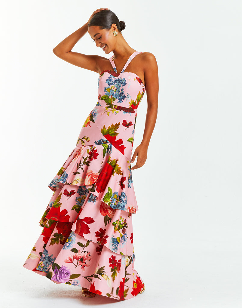 Pink tiered halter evening dress with vibrant floral print. The gown converts into a midi dress by unzipping bottom tier.