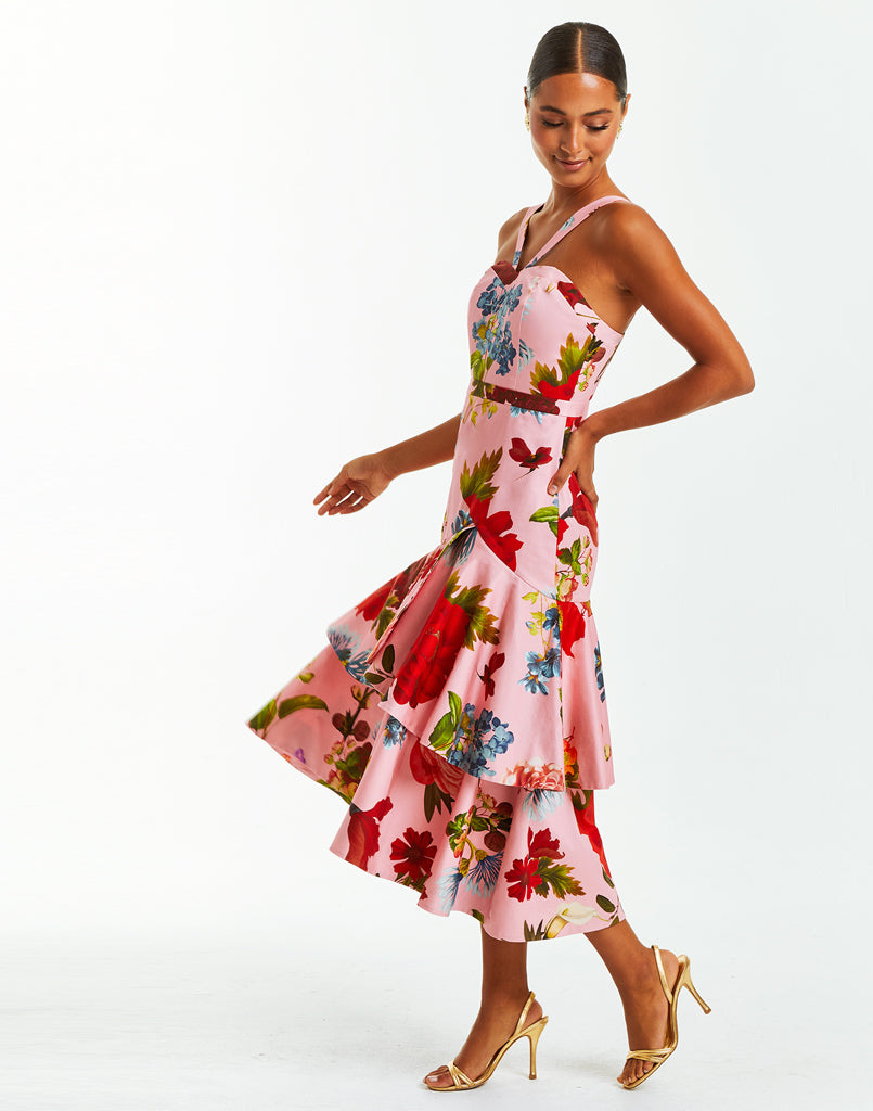 Pink tiered halter evening dress with vibrant floral print. The gown converts into a midi dress by unzipping bottom tier.