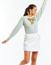 Tailored crew neck sweater with a front center  hand-beaded sparkly bow embellishment. 